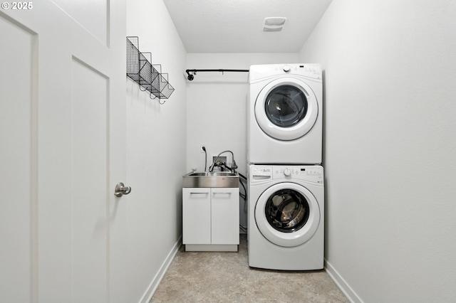 18 NE Cook St, Portland, OR 97212 - laundry area featuring stacked washer / dryer and cabinet space