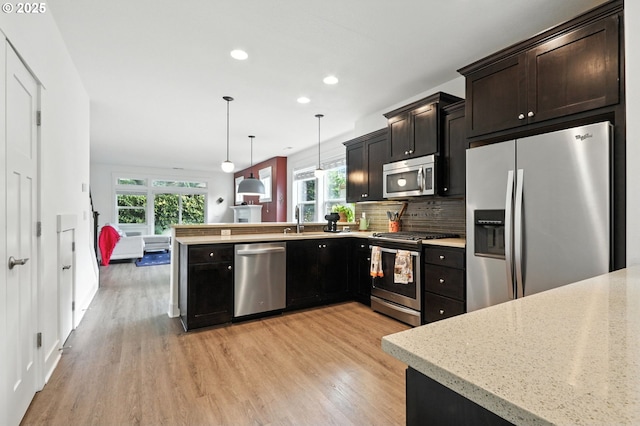 18 NE Cook St, Portland, OR 97212 - kitchen featuring stainless steel appliances, light wood-style flooring, healthy amount of natural light, and recessed lighting