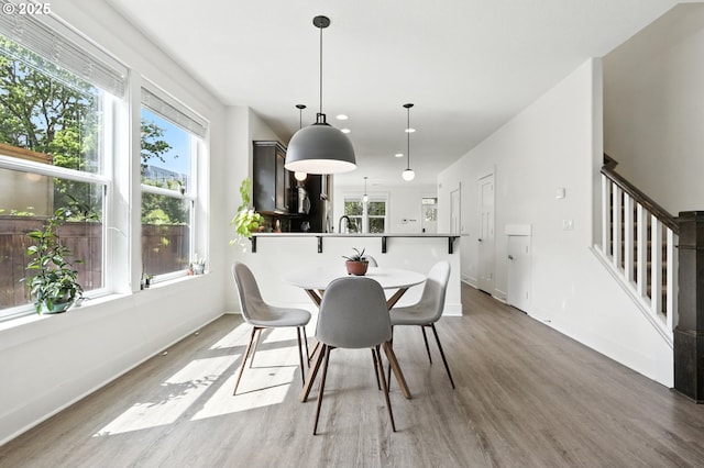 18 NE Cook St, Portland, OR 97212 - dining area featuring healthy amount of natural light, light wood finished floors, stairs, and recessed lighting