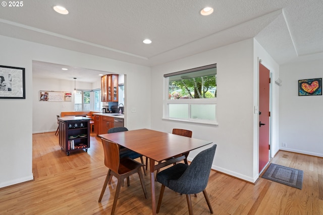 9004 SW 36th Ave, Portland, OR 97219 - dining room with light wood finished floors, baseboards, recessed lighting, and a textured ceiling