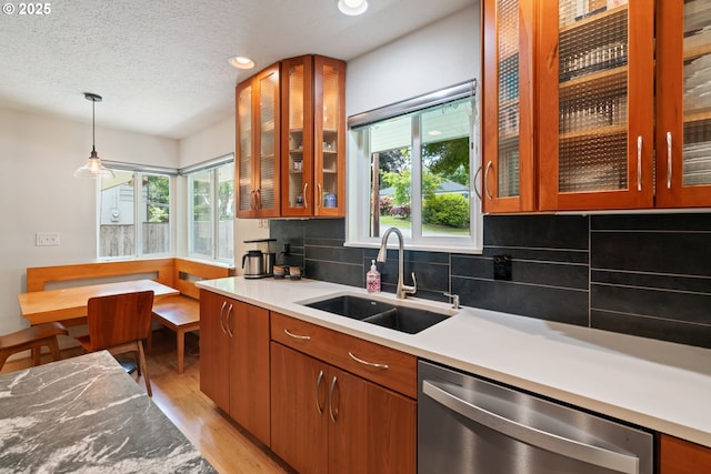 9004 SW 36th Ave, Portland, OR 97219 - kitchen with stainless steel dishwasher, a sink, plenty of natural light, light wood-style floors, and recessed lighting