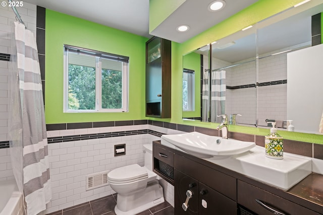 9004 SW 36th Ave, Portland, OR 97219 - bathroom with tile walls, toilet, vanity, tile patterned floors, and recessed lighting