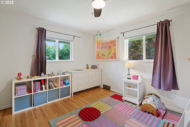 9004 SW 36th Ave, Portland, OR 97219 - bedroom featuring wood finished floors, multiple windows, and baseboards