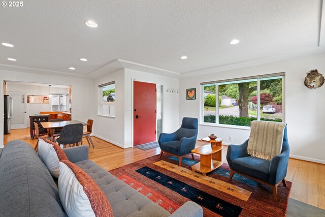9004 SW 36th Ave, Portland, OR 97219 - living room with a textured ceiling, light wood-style floors, recessed lighting, and baseboards