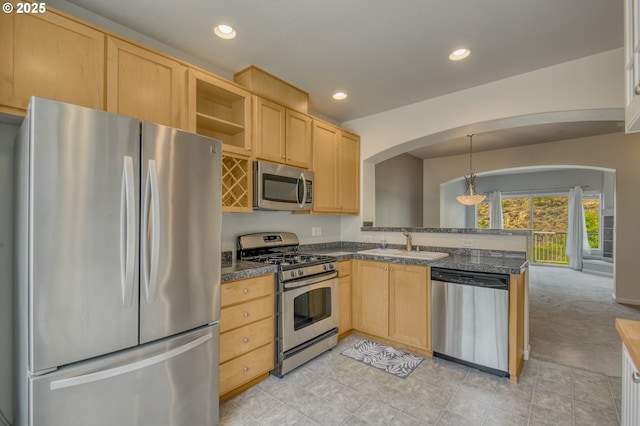 8800 SW 147th Ter Unit 103, Beaverton, OR 97007 - kitchen with appliances with stainless steel finishes, light brown cabinetry, arched walkways, dark countertops, and a peninsula