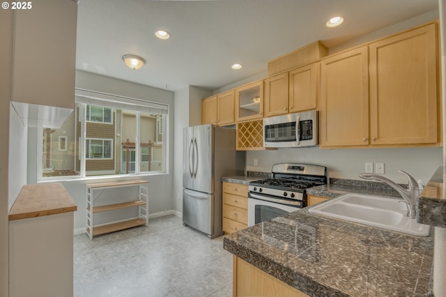 8800 SW 147th Ter Unit 103, Beaverton, OR 97007 - kitchen with appliances with stainless steel finishes, light brown cabinets, glass insert cabinets, tile countertops, and recessed lighting