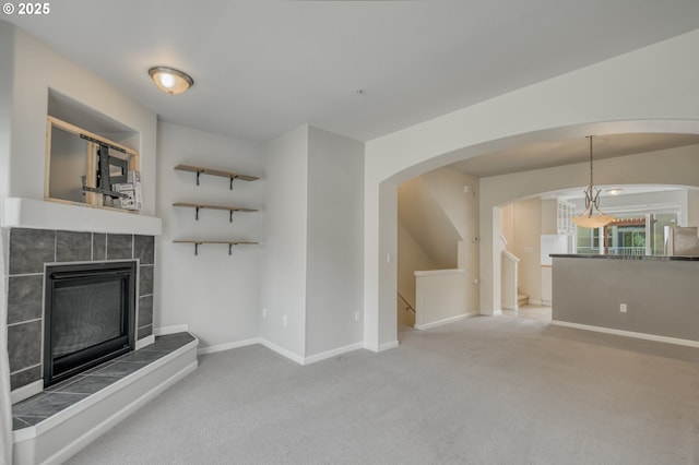 8800 SW 147th Ter Unit 103, Beaverton, OR 97007 - unfurnished living room featuring a tile fireplace and carpet flooring