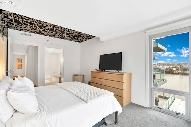 bedroom featuring visible vents, baseboards, light colored carpet, ensuite bath, and access to outside