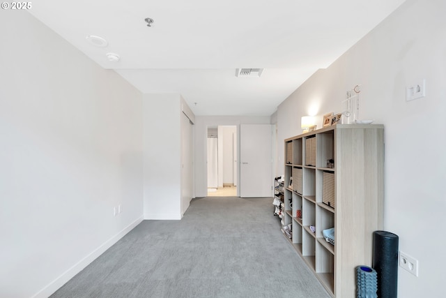 interior space featuring baseboards, visible vents, and carpet flooring