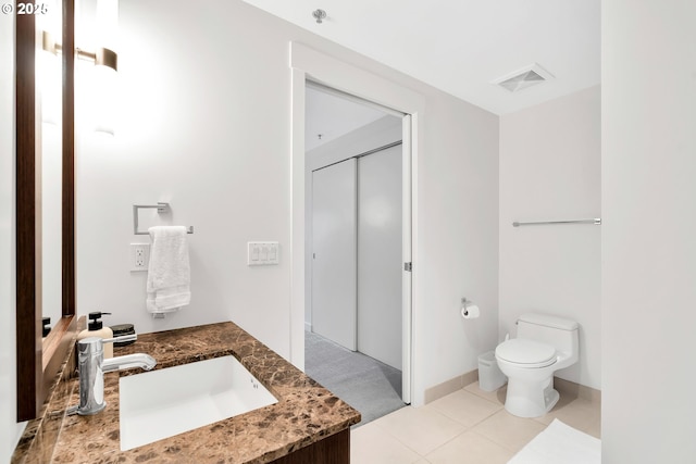 bathroom with visible vents, vanity, toilet, and tile patterned floors