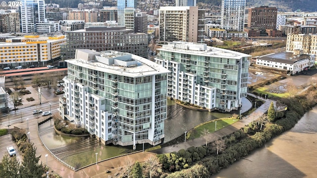 drone / aerial view featuring a water view and a city view