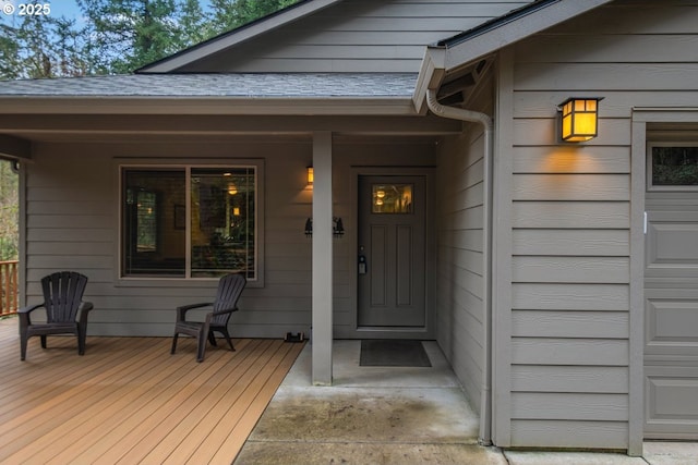 property entrance with a garage and a porch