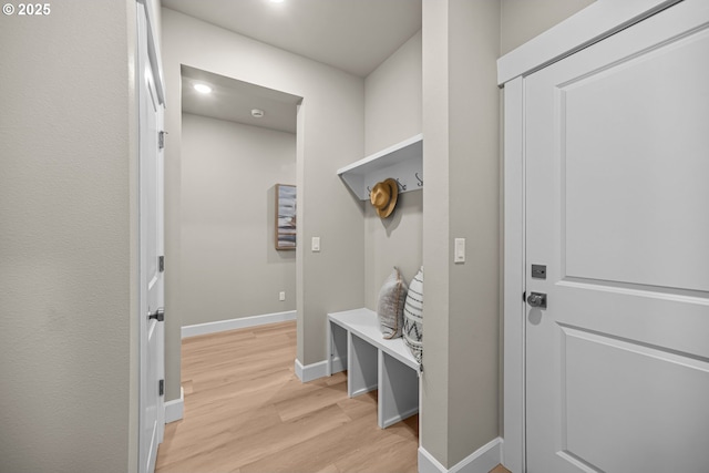 mudroom with baseboards and light wood finished floors