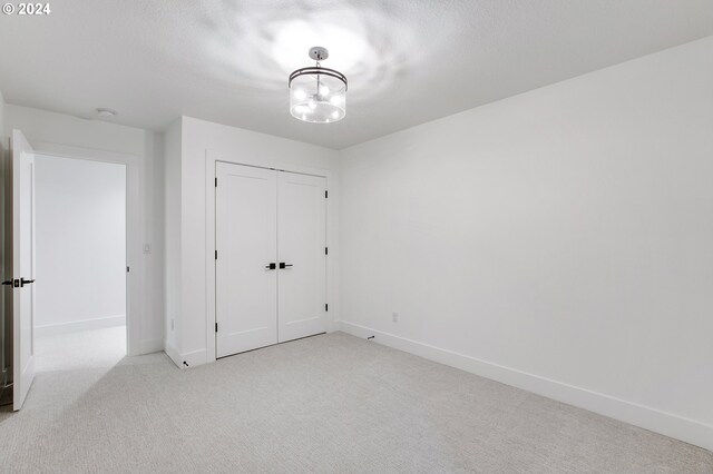 unfurnished bedroom featuring carpet, a closet, and baseboards