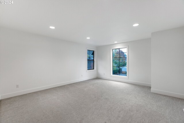 empty room with recessed lighting, baseboards, and light colored carpet