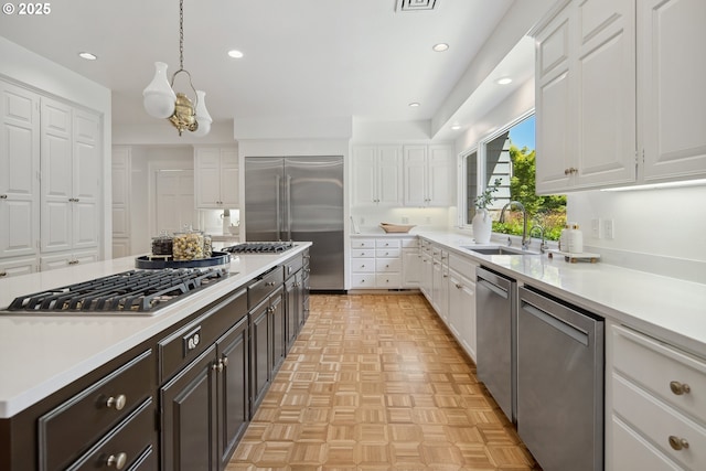 1890 S Greenwood Rd, Portland, OR 97219 - kitchen with a sink, stainless steel appliances, white cabinetry, light countertops, and recessed lighting