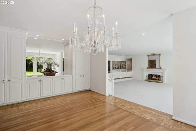 1890 S Greenwood Rd, Portland, OR 97219 - unfurnished dining area featuring a chandelier, recessed lighting, a warm lit fireplace, baseboards, and parquet flooring