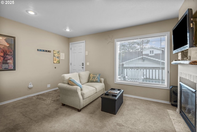living room featuring a tiled fireplace, baseboards, recessed lighting, and light colored carpet