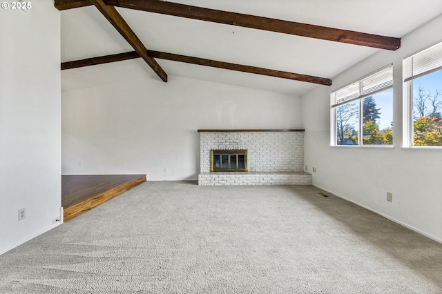 unfurnished living room featuring vaulted ceiling with beams, carpet, and a brick fireplace
