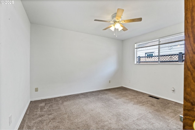 unfurnished room featuring baseboards, carpet, a ceiling fan, and visible vents