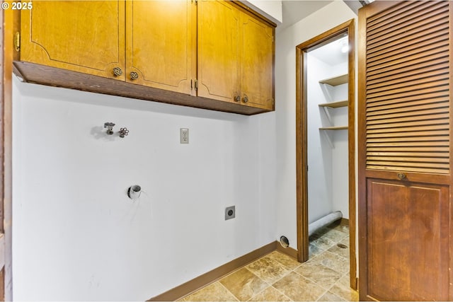 washroom with cabinet space, hookup for an electric dryer, stone finish flooring, and baseboards