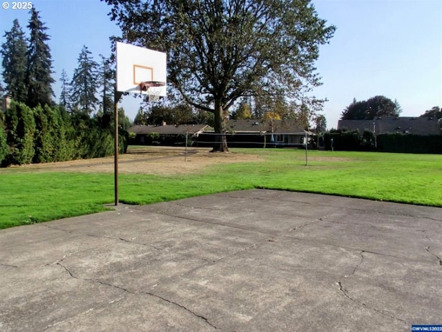view of basketball court with a lawn and community basketball court