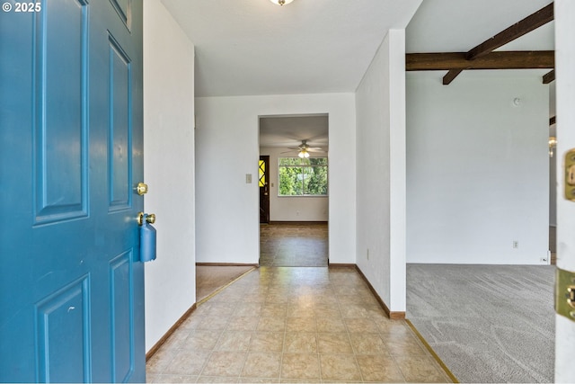 entryway with baseboards and ceiling fan