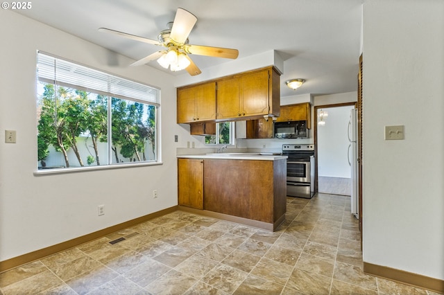 kitchen featuring stainless steel electric range, black microwave, brown cabinetry, a peninsula, and visible vents