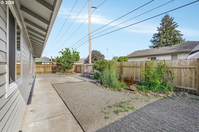 fenced backyard with a patio area