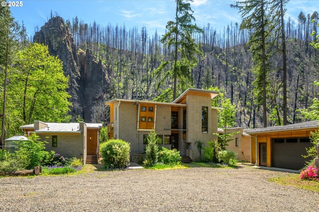 49348 Mckenzie Hwy, Vida, OR 97488 - view of front of house with a mountain view, gravel driveway, and a forest view