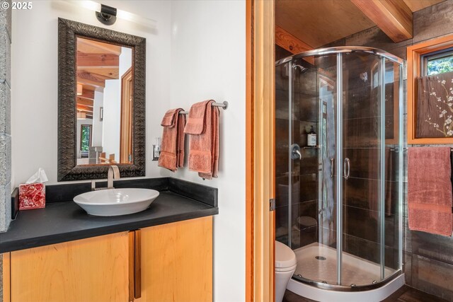 49348 Mckenzie Hwy, Vida, OR 97488 - full bathroom with a shower stall, beamed ceiling, vanity, and toilet