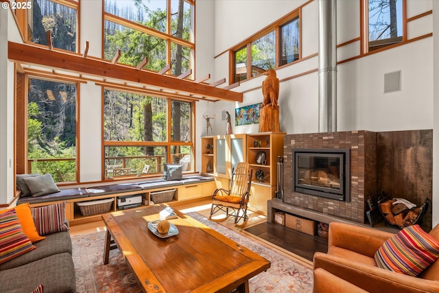 49348 Mckenzie Hwy, Vida, OR 97488 - living area with a high ceiling, wood finished floors, and a glass covered fireplace