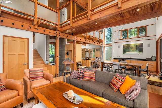 49348 Mckenzie Hwy, Vida, OR 97488 - living area with a towering ceiling, stairs, beam ceiling, and wood finished floors