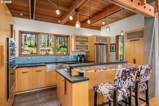 49348 Mckenzie Hwy, Vida, OR 97488 - kitchen with freestanding refrigerator, rail lighting, wood ceiling, a sink, and dark countertops