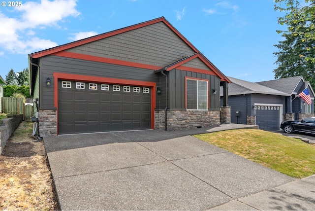 31070 NW Kaybern St, North Plains, OR 97133 - craftsman-style home with stone siding, an attached garage, board and batten siding, and driveway