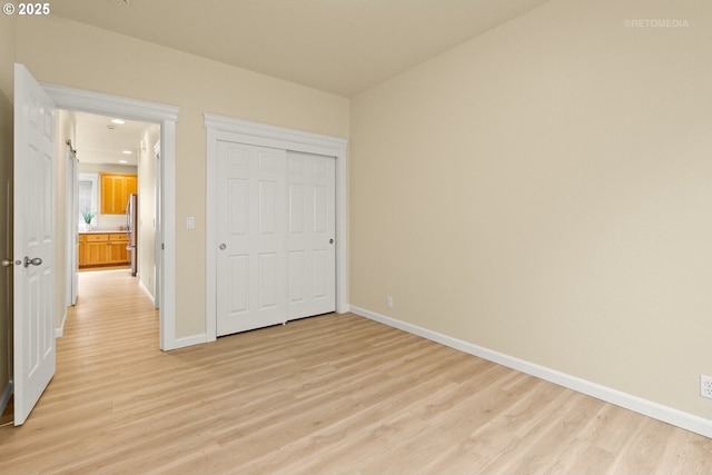 31070 NW Kaybern St, North Plains, OR 97133 - unfurnished bedroom with light wood-style floors, a closet, freestanding refrigerator, and recessed lighting
