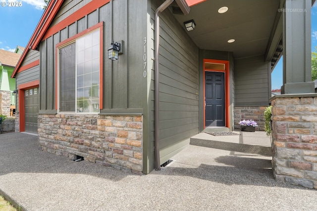 31070 NW Kaybern St, North Plains, OR 97133 - doorway to property with an attached garage and stone siding