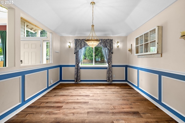 1670 NE Jackson School Rd, Hillsboro, OR 97124 - unfurnished dining area with wood finished floors, wainscoting, and a decorative wall