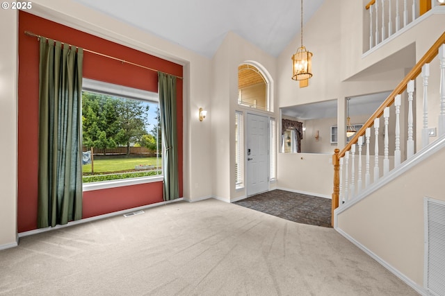 1670 NE Jackson School Rd, Hillsboro, OR 97124 - carpeted foyer entrance featuring a chandelier, baseboards, stairway, and high vaulted ceiling