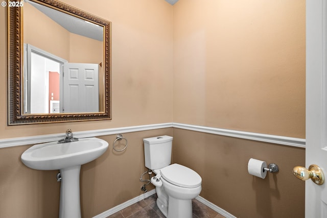1670 NE Jackson School Rd, Hillsboro, OR 97124 - half bathroom with toilet, tile patterned flooring, and baseboards