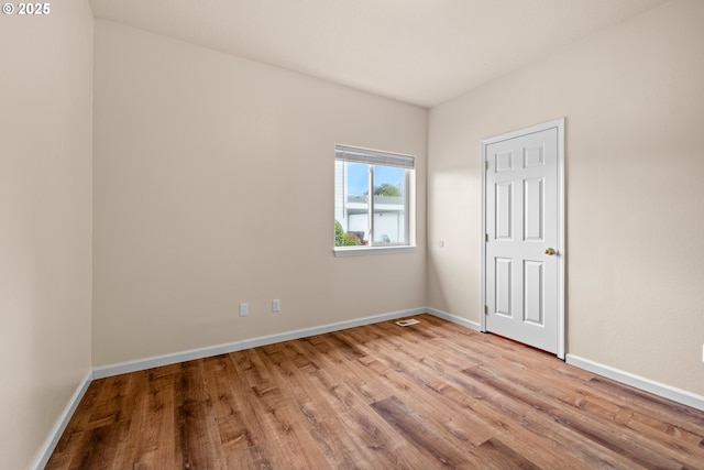 1670 NE Jackson School Rd, Hillsboro, OR 97124 - unfurnished bedroom featuring wood finished floors and baseboards