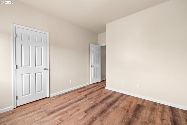 1670 NE Jackson School Rd, Hillsboro, OR 97124 - unfurnished bedroom featuring wood finished floors and baseboards