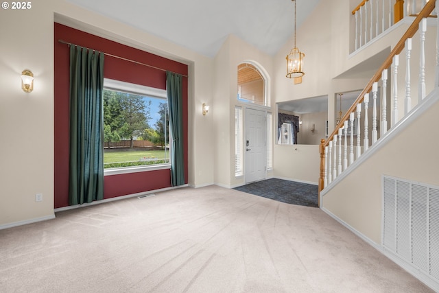 1670 NE Jackson School Rd, Hillsboro, OR 97124 - carpeted foyer with a chandelier, baseboards, and a high ceiling