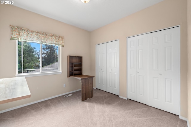 1670 NE Jackson School Rd, Hillsboro, OR 97124 - unfurnished bedroom featuring carpet, two closets, and baseboards