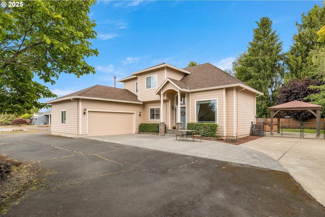1670 NE Jackson School Rd, Hillsboro, OR 97124 - view of front facade with a gazebo, asphalt driveway, an attached garage, and roof with shingles