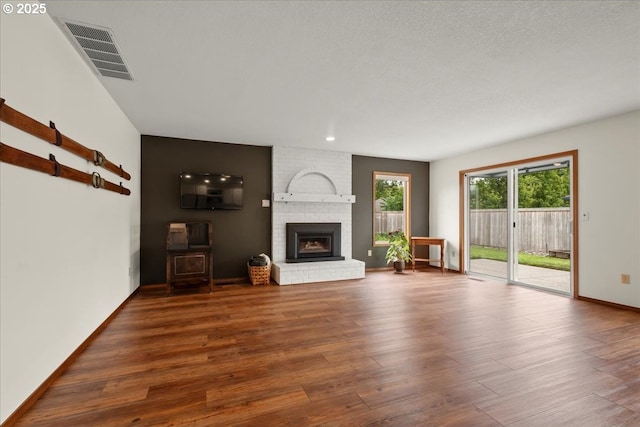 817 NW 141st St, Vancouver, WA 98685 - unfurnished living room with wood finished floors and a brick fireplace