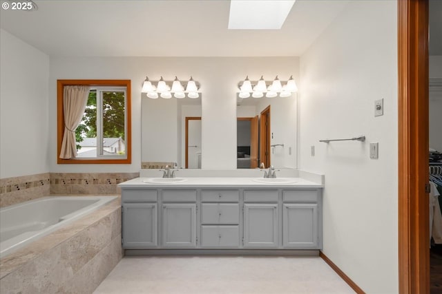 817 NW 141st St, Vancouver, WA 98685 - bathroom featuring a skylight, double vanity, and a bath