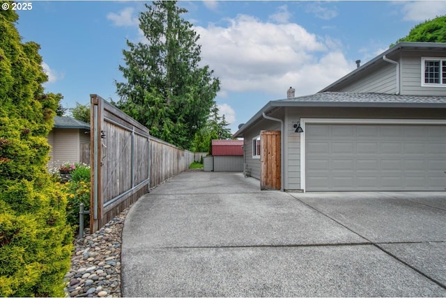 817 NW 141st St, Vancouver, WA 98685 - view of side of property with concrete driveway, a garage, and roof with shingles