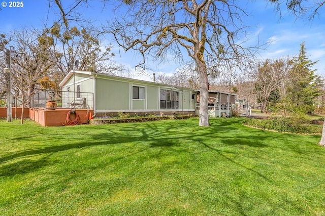 rear view of house featuring a lawn