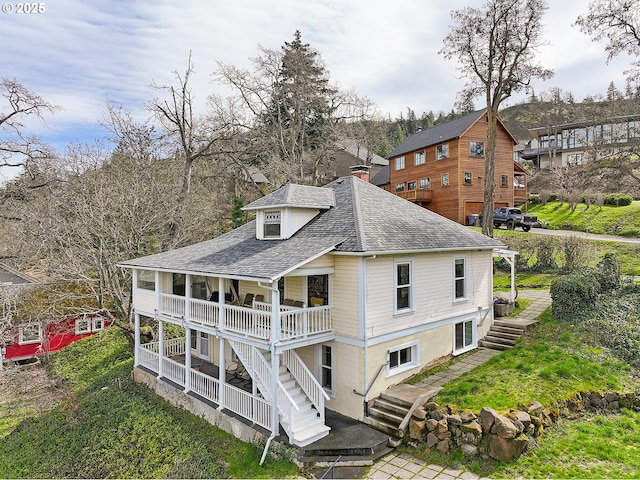 1006 4th Ave, Mosier, OR 97040 - rear view of house with stairs, a shingled roof, and a chimney